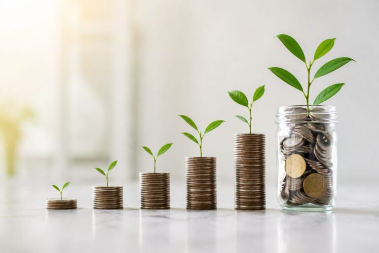 Compound interest concept showing growing stacks of coins with young plants, representing long-term wealth creation through investing and personal finance.